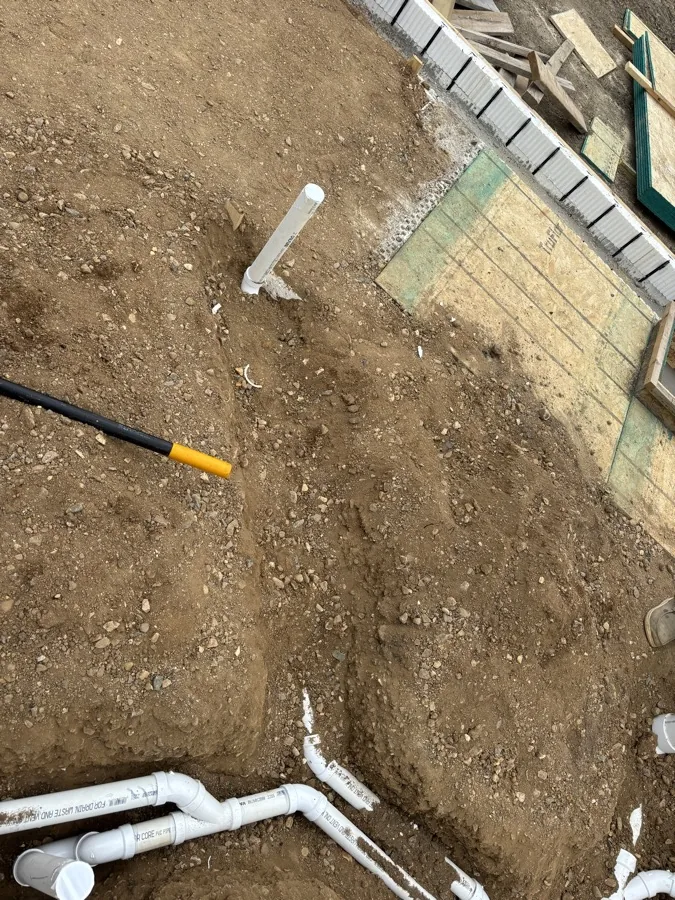 Underground plumbing pipes routed before concrete work
